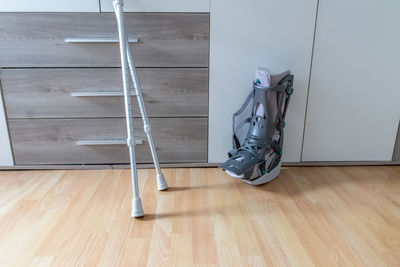 Low section of man standing on hardwood floor