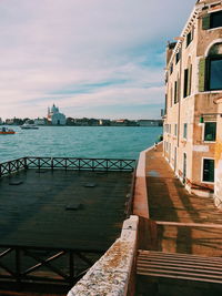 Pier over sea against buildings in city