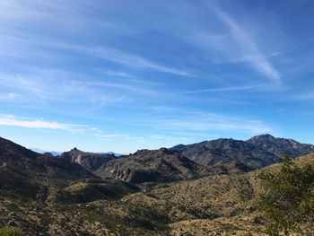 Scenic view of mountains against blue sky