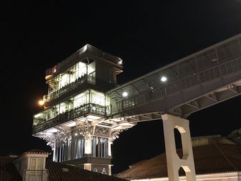 Low angle view of illuminated buildings against sky at night