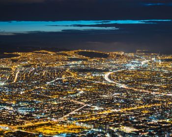 Aerial view of illuminated cityscape against sky at night