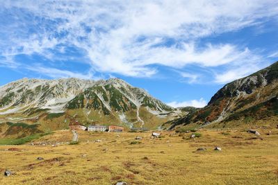 Scenic view of mountains against cloudy sky