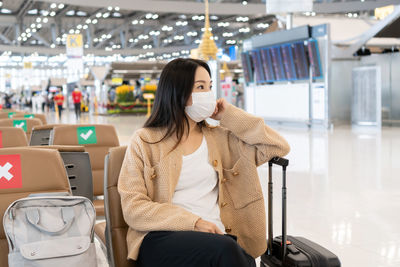 Portrait of young woman waiting at airport