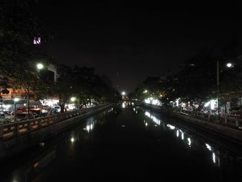 Illuminated bridge against sky at night