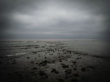 Scenic view of sea against cloudy sky