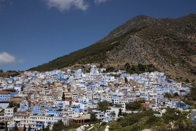 Townscape by mountain against sky