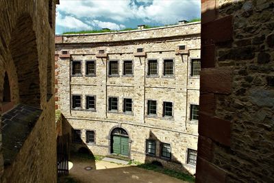 View of old building against cloudy sky