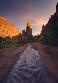 Rock formations on land against sky during sunset