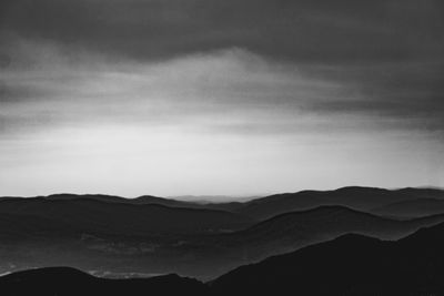 Scenic view of silhouette mountains against sky