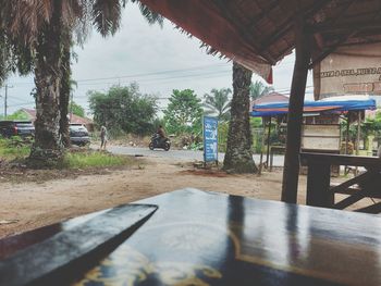 People on table in restaurant against building