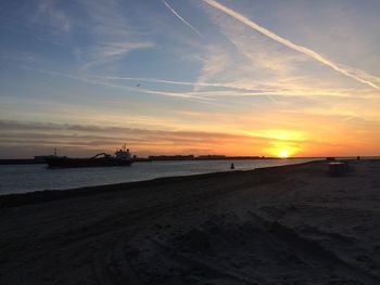Scenic view of beach against sky during sunset