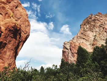 Low angle view of rock formation against cloudy sky