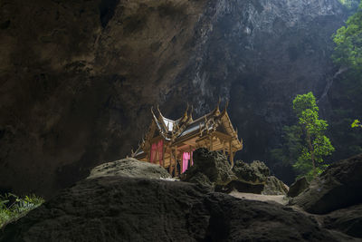 Low angle view of person on rock in cave