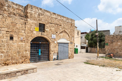 Exterior of building by street against sky
