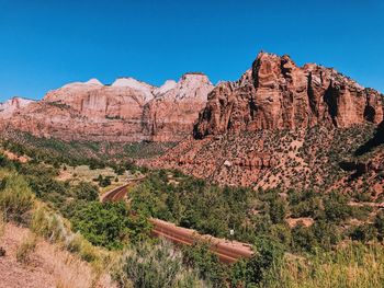 Scenic view of rocky mountains against clear blue sky