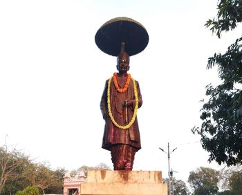 Low angle view of statue against sky