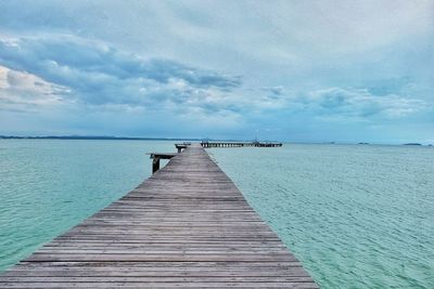 Pier over sea against sky