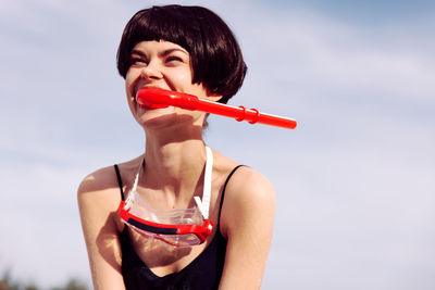 Portrait of young woman holding ice cream