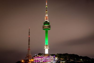 Communications tower in city at night