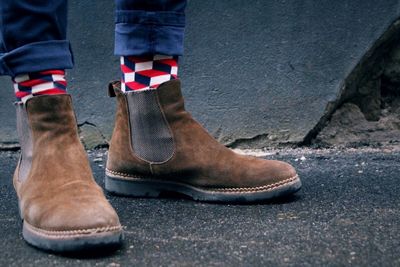 Low section of a man standing on ground