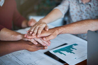 Midsection of business people working on table