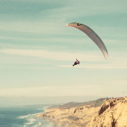 People paragliding in sky