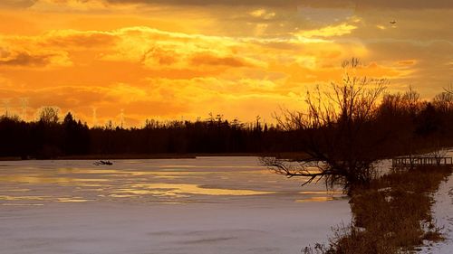 Scenic view of lake at sunset