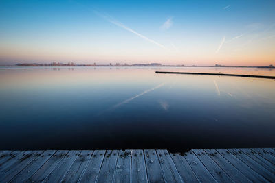 Scenic view of lake against sky during sunset