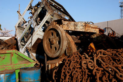 Old rusty wheel against sky