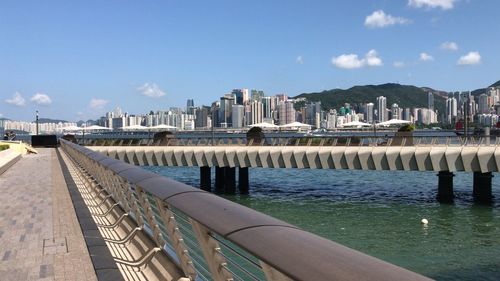 Panoramic view of city by seaside walkway outside k11 and buildings against sky