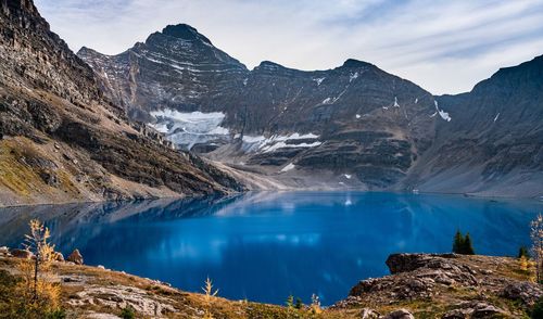 Scenic view of lake and mountains against sky