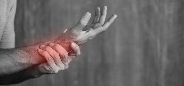 Close-up of hand against wall