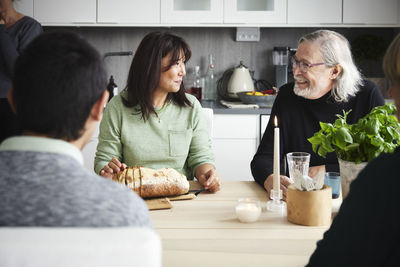 Family sitting at table and having conversation