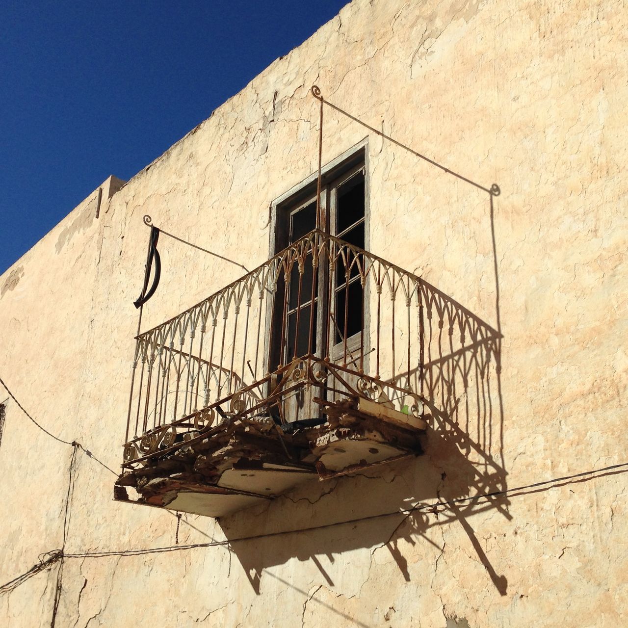 LOW ANGLE VIEW OF RUSTY ABANDONED BUILDING