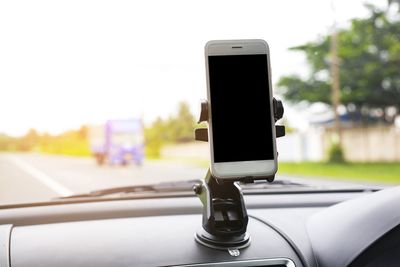 Close-up of mobile phone in car