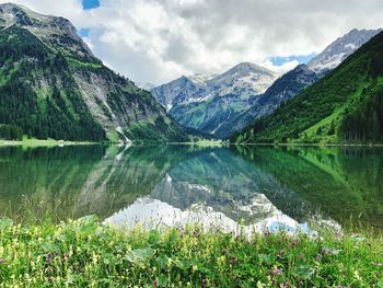 Scenic view of lake and mountains against sky