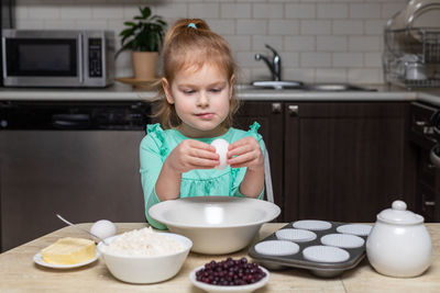 Portrait of boy eating food at home