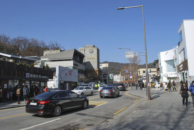 Traffic on city street against clear sky