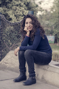 Portrait of young woman sitting outdoors