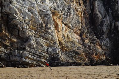 Surfboard in front of rocks