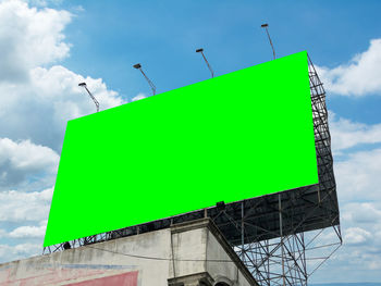 Low angle view of road sign against sky