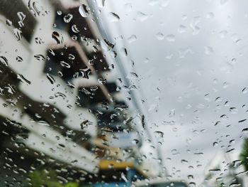 Full frame shot of wet glass window in rainy season