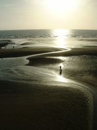 Silhouette of man walking on beach