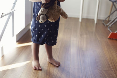 Child holding stuffed toys