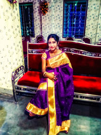 Portrait of smiling young woman sitting outdoors