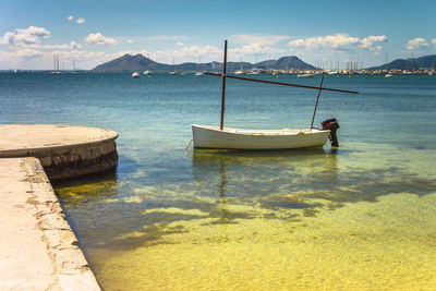 Boat moored on sea against sky