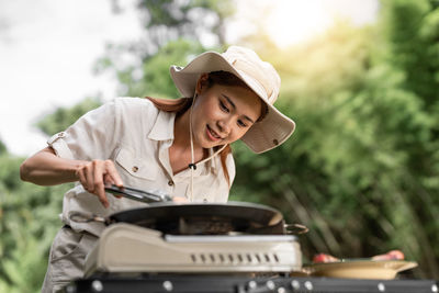 Side view of woman using mobile phone