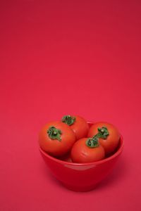 High angle view of vegetables on red background