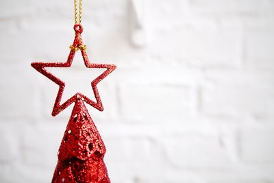 Close-up of tree topper against wall at home