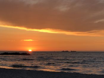 Scenic view of sea against orange sky